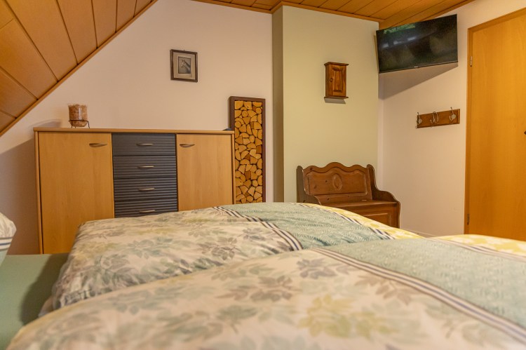 Gemütliches Schlafzimmer mit Bett und und Kommode